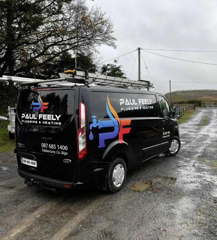 Paul Feely Plumbing and Heating branded black Ford Transit van on a rural Sligo road